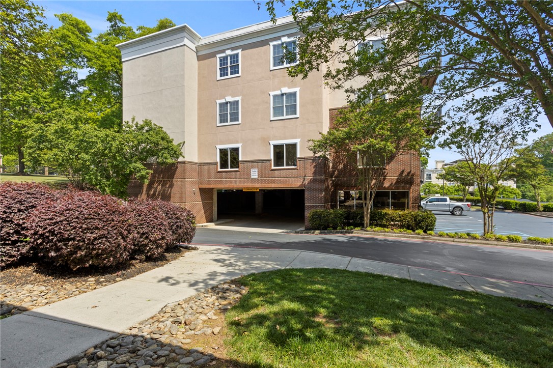 101 Oak Street, Unit 401 Clemson, SC 29631 - Photo 19 of 26 This modern multi-story building features a convenient covered parking garage, combining practicality with appealing architecture.