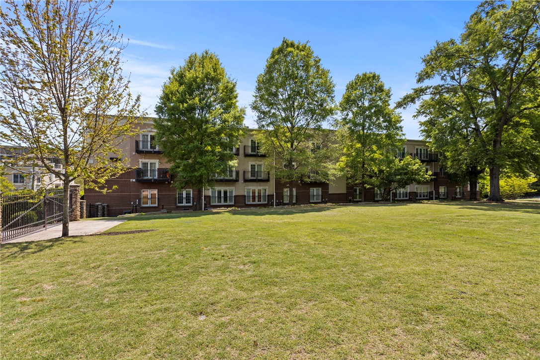 101 Oak Street, Unit 401 Clemson, SC 29631 - Photo 20 of 26 This property features a multi-story building with balconies overlooking a spacious green area.