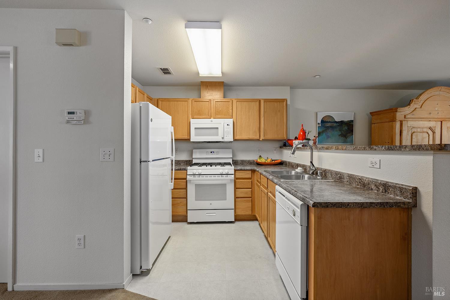 84 Crissy Place Novato, CA 94949 - Photo 13 of 37 a kitchen with stainless steel appliances granite countertop a refrigerator and a sink