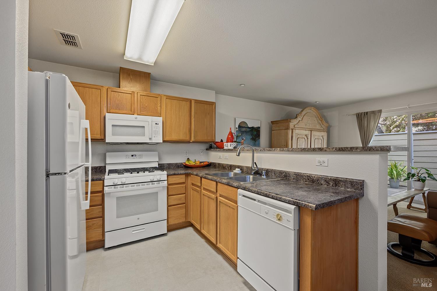 84 Crissy Place Novato, CA 94949 - Photo 14 of 37 a kitchen with stainless steel appliances granite countertop a sink stove and refrigerator