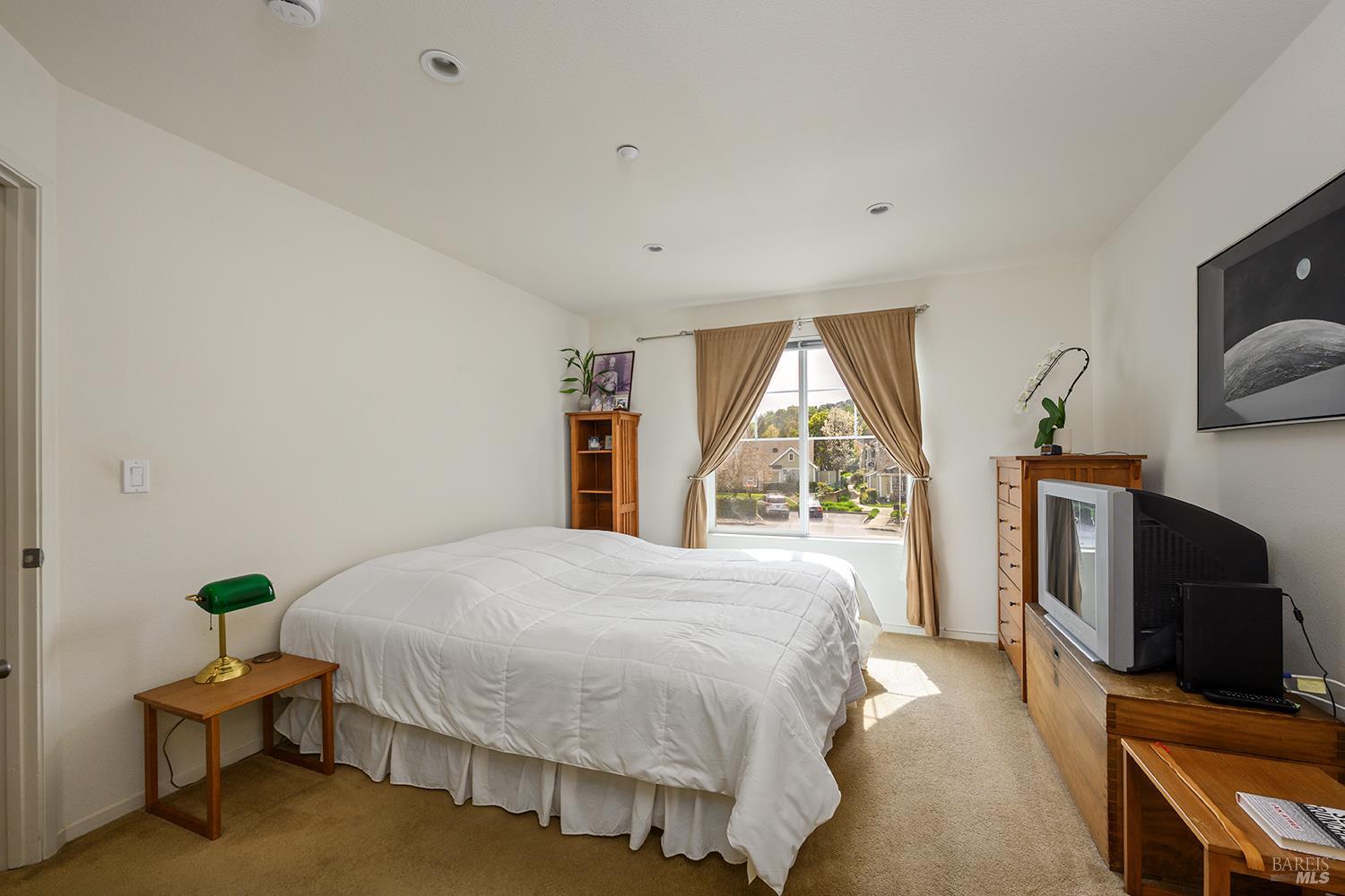 84 Crissy Place Novato, CA 94949 - Photo 30 of 37 a bedroom with a bed a flat tv screen and a window