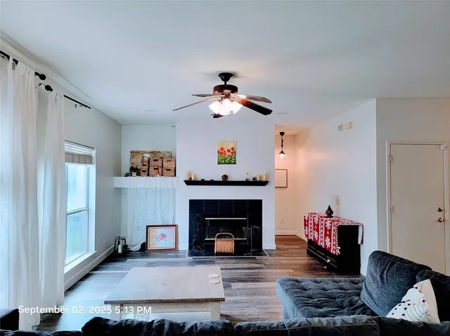 a living room with furniture and a fireplace