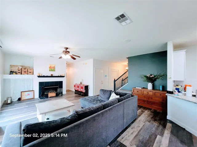 a living room with furniture and a fireplace