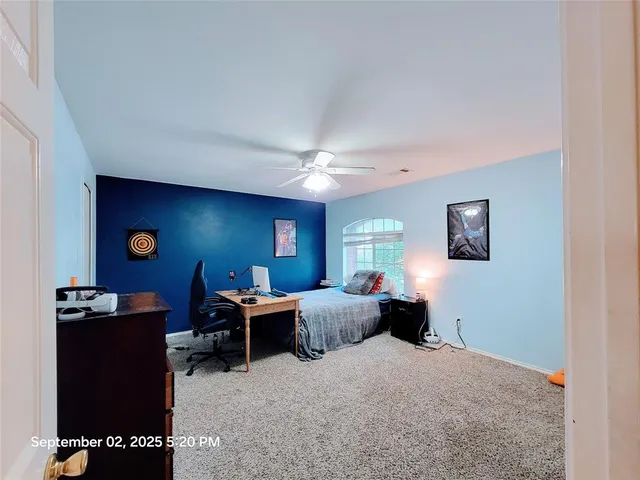 a living room with furniture a window and a flat screen tv