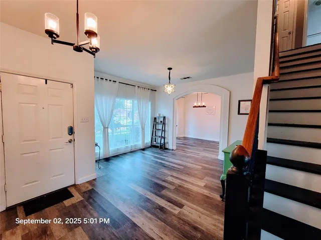 a view of an entryway with wooden floor