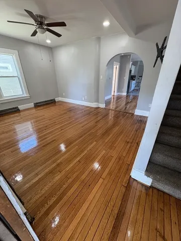 a view of a room with wooden floor