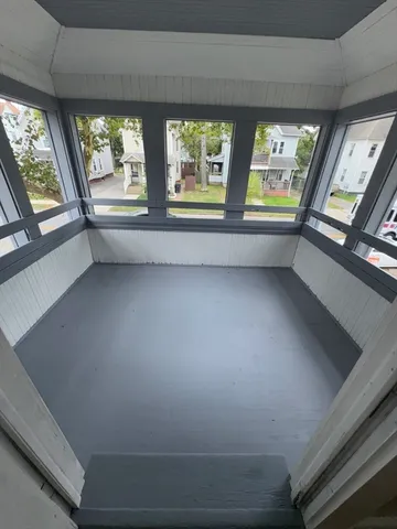 a view of an empty room with large windows