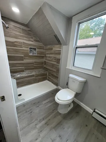 a bathroom with a toilet and a shower