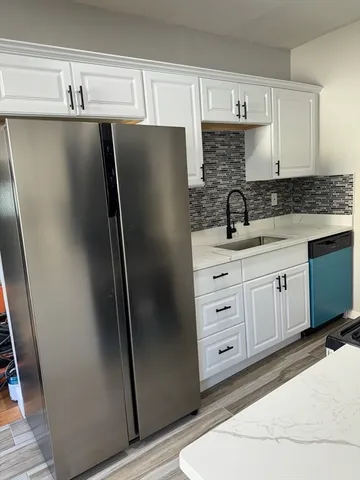 a kitchen with stainless steel appliances a refrigerator sink and cabinets