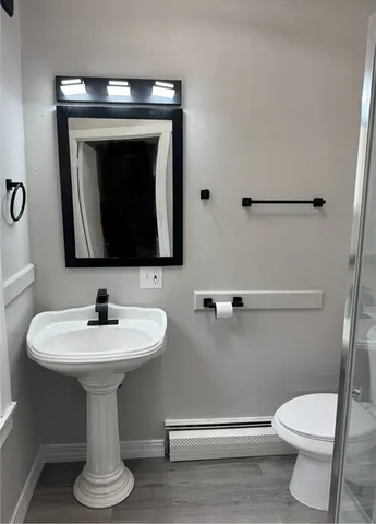 a bathroom with a toilet sink and mirror