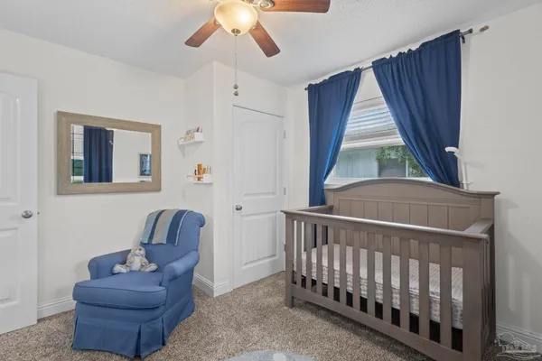 a bathroom with a tub toilet and a window