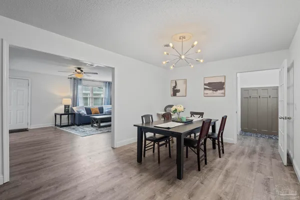 a view of a dining room with furniture and wooden floor