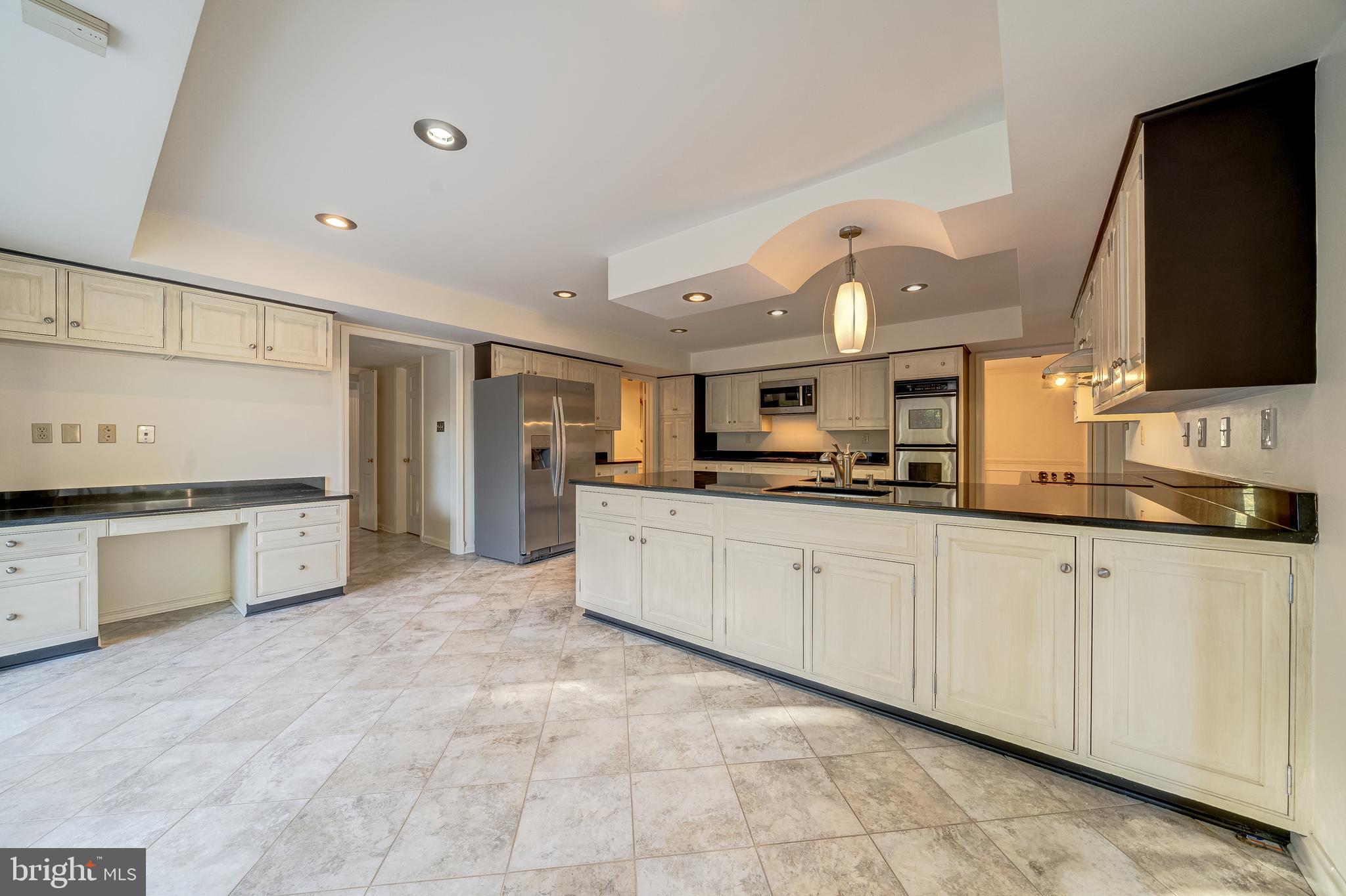 6209 Stoneham Lane McLean, VA 22101 - Photo 14 of 49 a large kitchen with cabinets