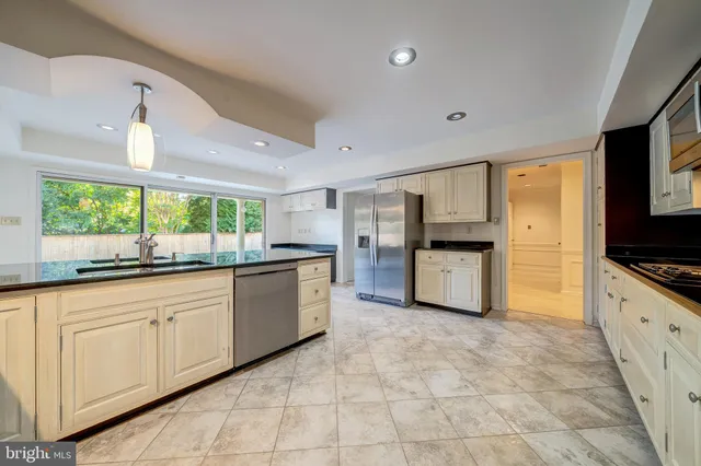 a view of an empty room with a large window and doors