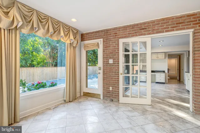 a view of an empty room with glass door
