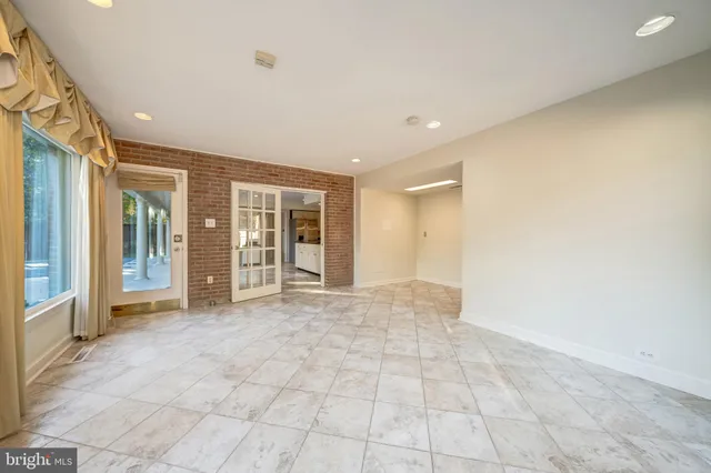 a view of a bedroom with a bed and a window