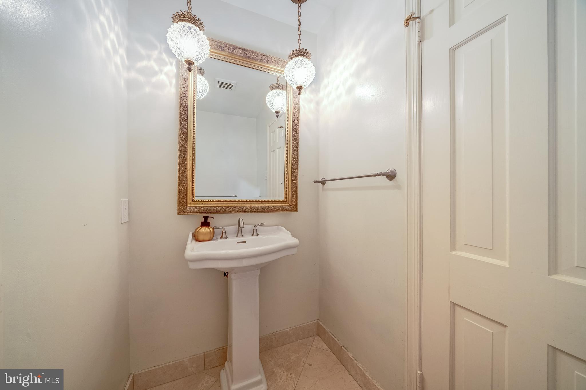 6209 Stoneham Lane McLean, VA 22101 - Photo 26 of 49 a bathroom with a sink a light fixture and a mirror