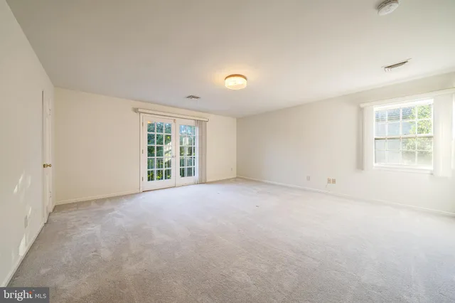 a spacious bathroom with a double vanity sink a large mirror and shower