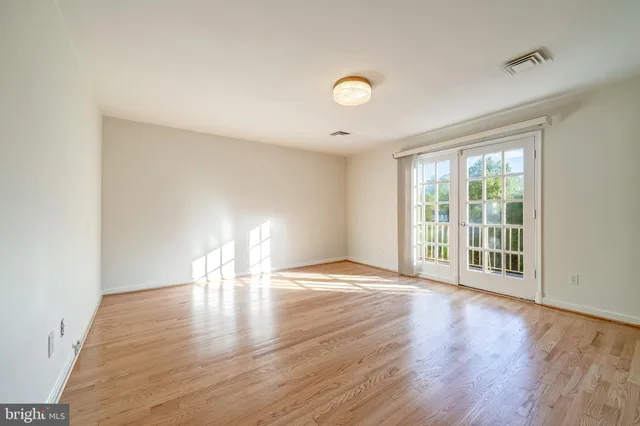 a spacious bathroom with a granite countertop sink a toilet a mirror and shower