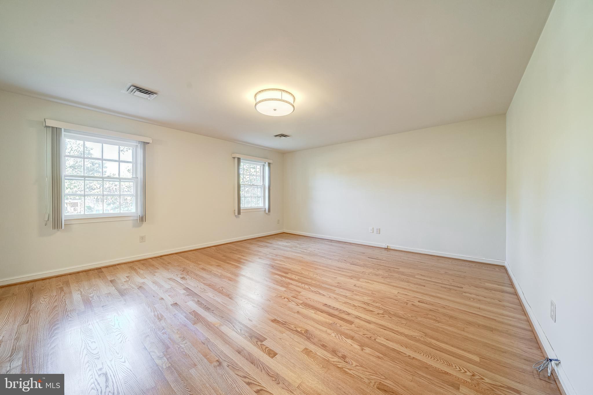 6209 Stoneham Lane McLean, VA 22101 - Photo 38 of 49 an empty room with wooden floor and windows