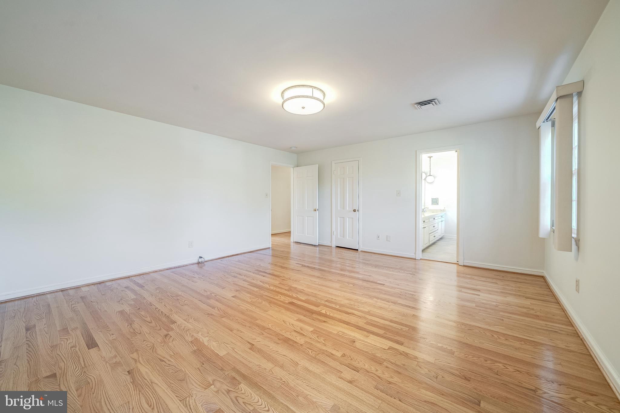 6209 Stoneham Lane McLean, VA 22101 - Photo 39 of 49 an empty room with wooden floor and windows