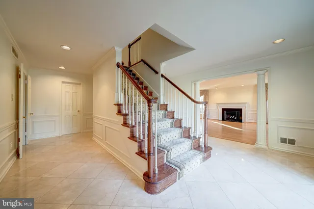 a view of an empty room with a window and fireplace