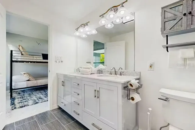 a bathroom with a double vanity sink mirror and shower