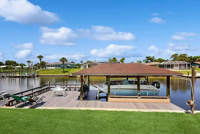 a view of a lake with a house in the background