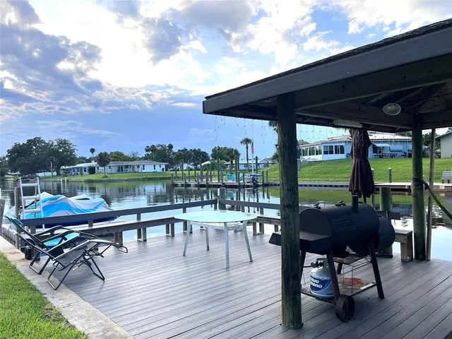 a roof deck with outdoor seating and city view