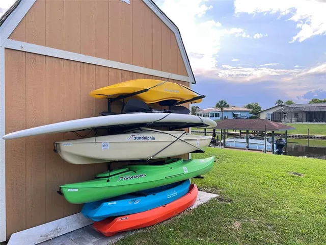 a backyard of a house with table and chairs