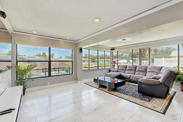 a living room with furniture and large windows