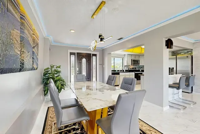 a view of a dining room with furniture and chandelier