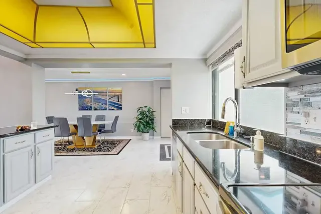 a kitchen with a sink and cabinets