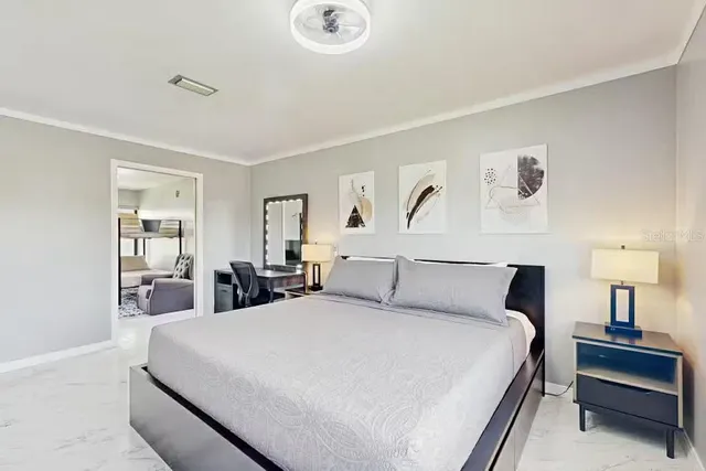 a bedroom with a bed and a lamp