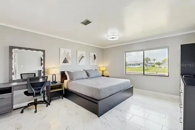 a living room with a bed furniture and a large window