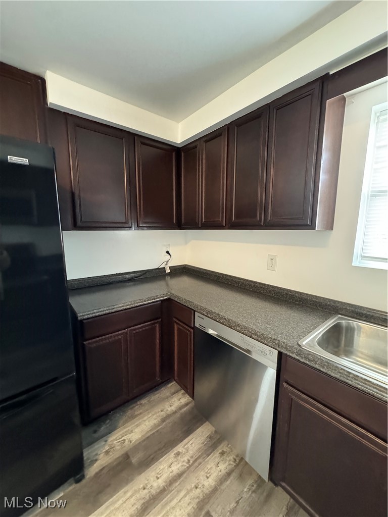 5155 Center Road Philo, OH 43771 - Photo 12 of 37 Kitchen with dark brown cabinetry, dishwasher, light hardwood / wood-style floors, and fridge