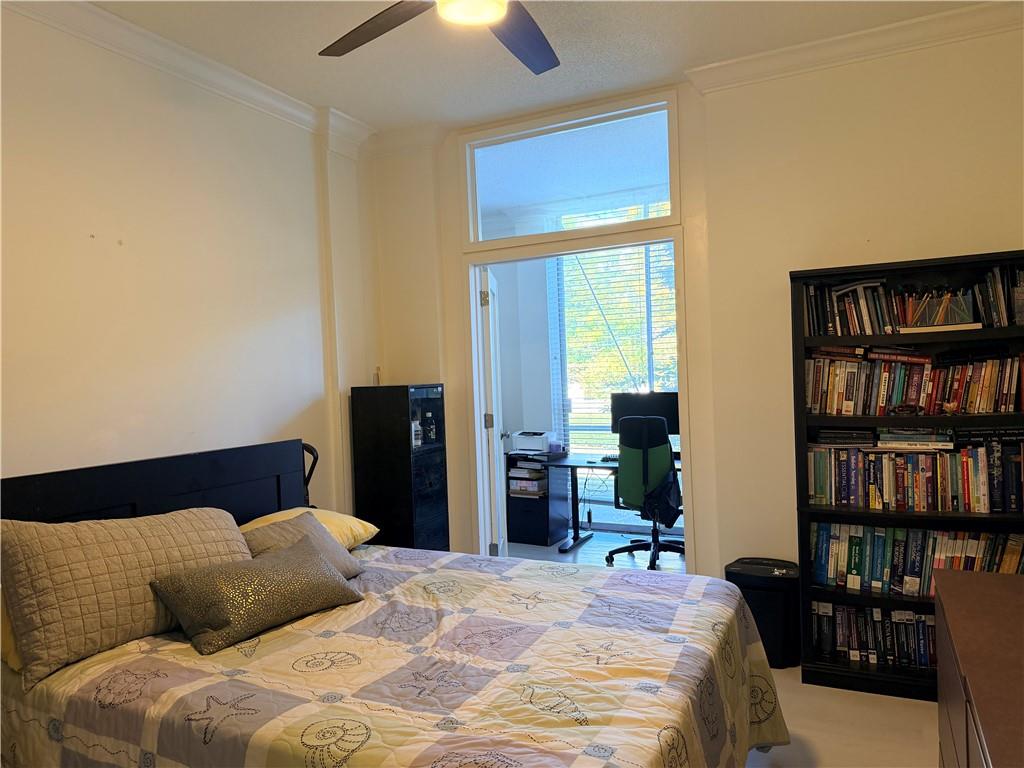 130 Twenty 6th Street, Unit 214 Atlanta, GA 30344 - Photo 11 of 42 a bedroom with a bed furniture and a book shelf