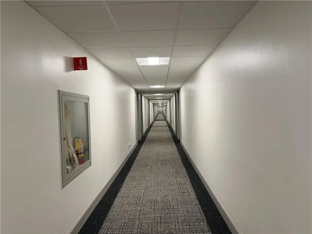 a view of hallway with wooden floor