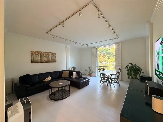 a living room with furniture wooden floor and a table