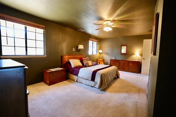 a living room with furniture a flat screen tv and lamp