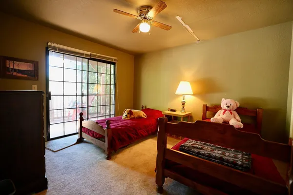 a spacious bedroom with a bed and a lamp