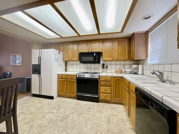 a kitchen with a stove a sink and a refrigerator