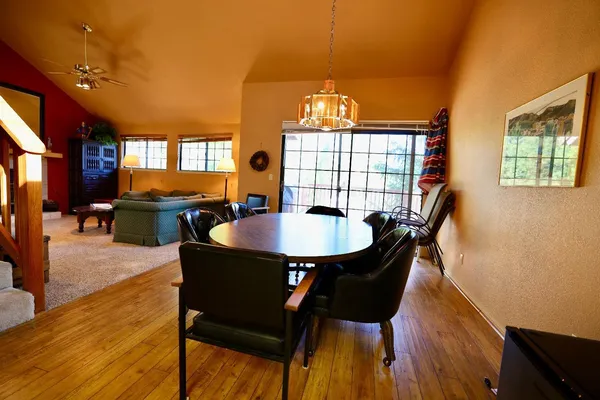 a view of a dining room with furniture and wooden floor