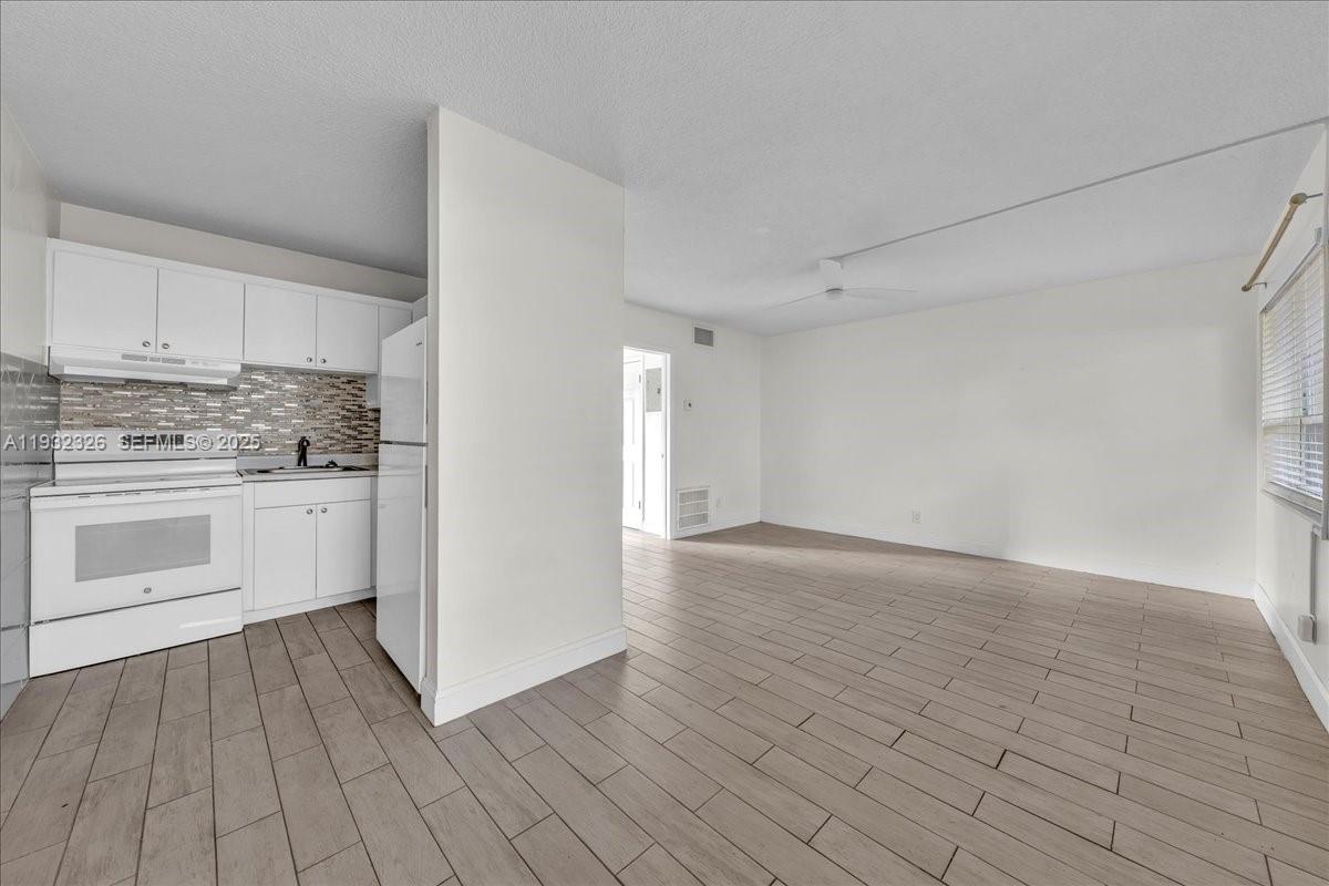 2025 Miami Road, Unit 19 Fort Lauderdale, FL 33316 - Photo 12 of 30 a view of a kitchen with dishwasher and a stove top oven