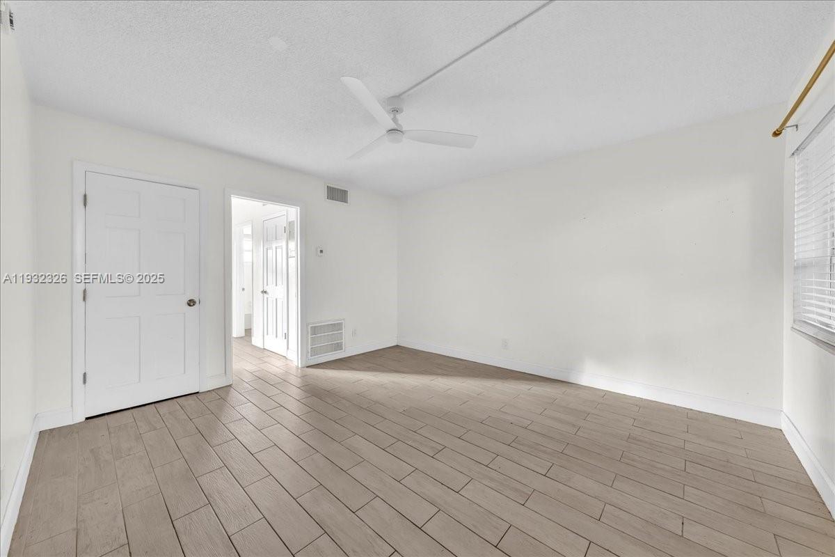 2025 Miami Road, Unit 19 Fort Lauderdale, FL 33316 - Photo 16 of 30 a view of an empty room and wooden floor