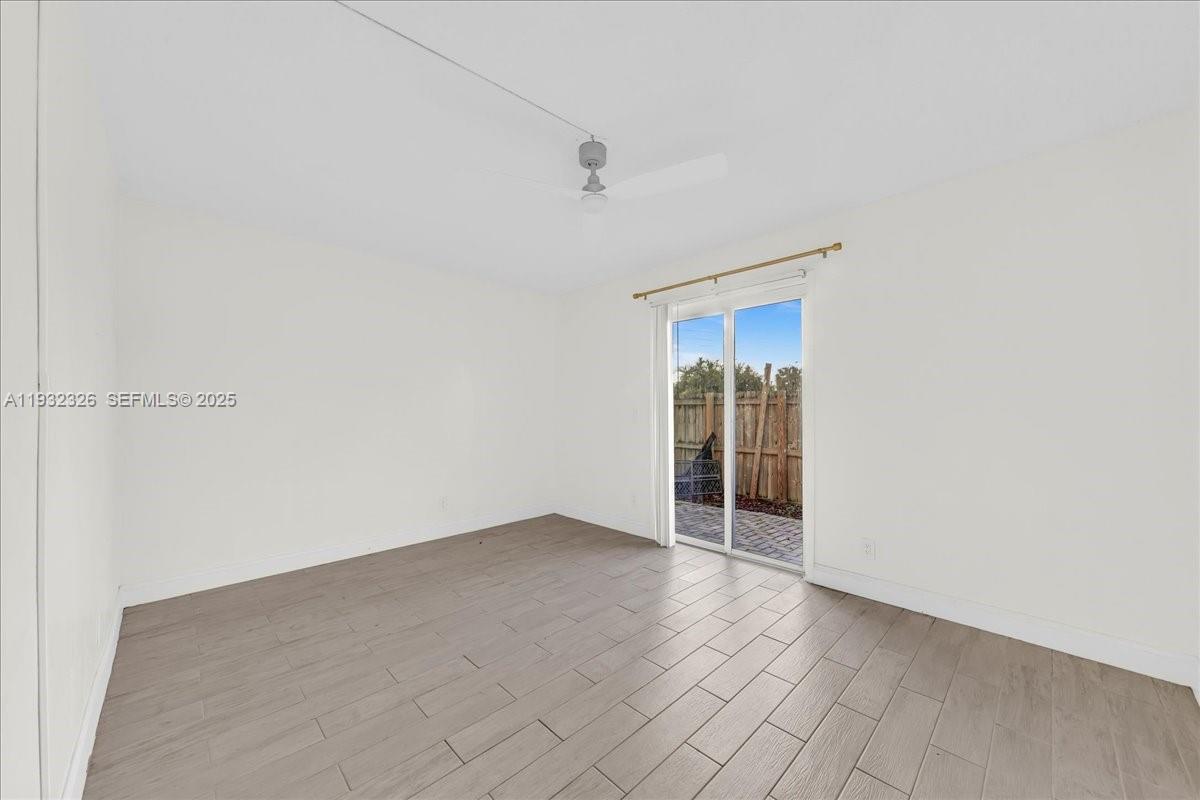 2025 Miami Road, Unit 19 Fort Lauderdale, FL 33316 - Photo 17 of 30 a view of an empty room with wooden floor and a window