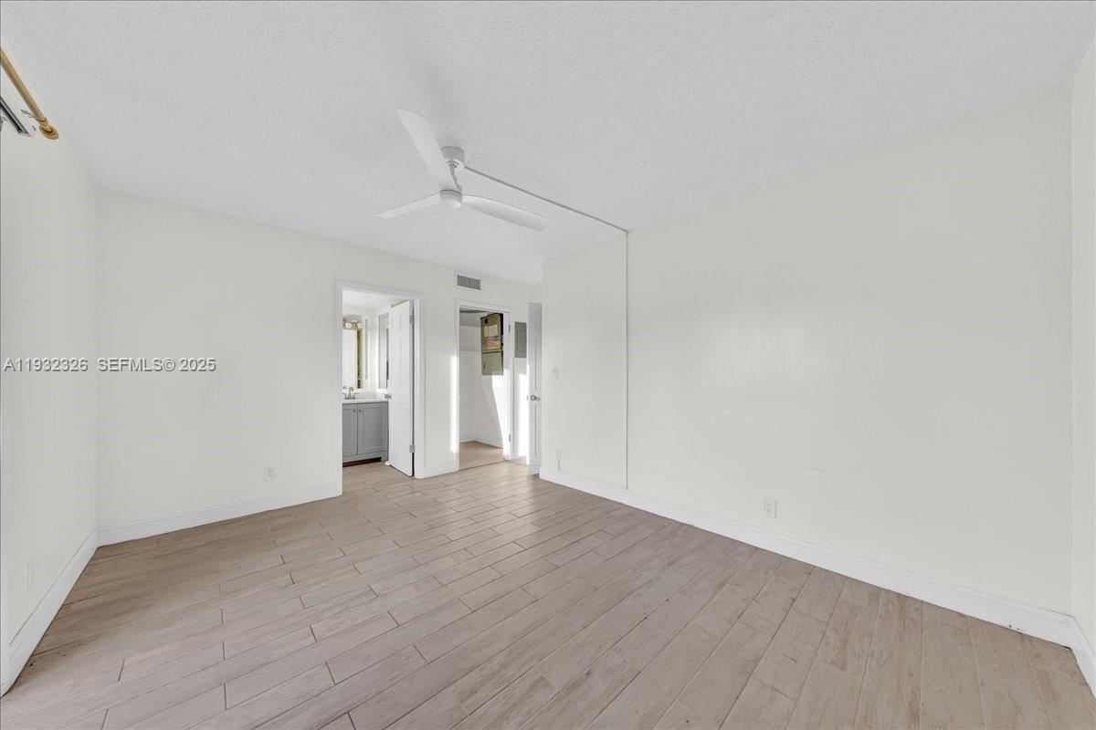 2025 Miami Road, Unit 19 Fort Lauderdale, FL 33316 - Photo 21 of 30 a view of an empty room with wooden floor