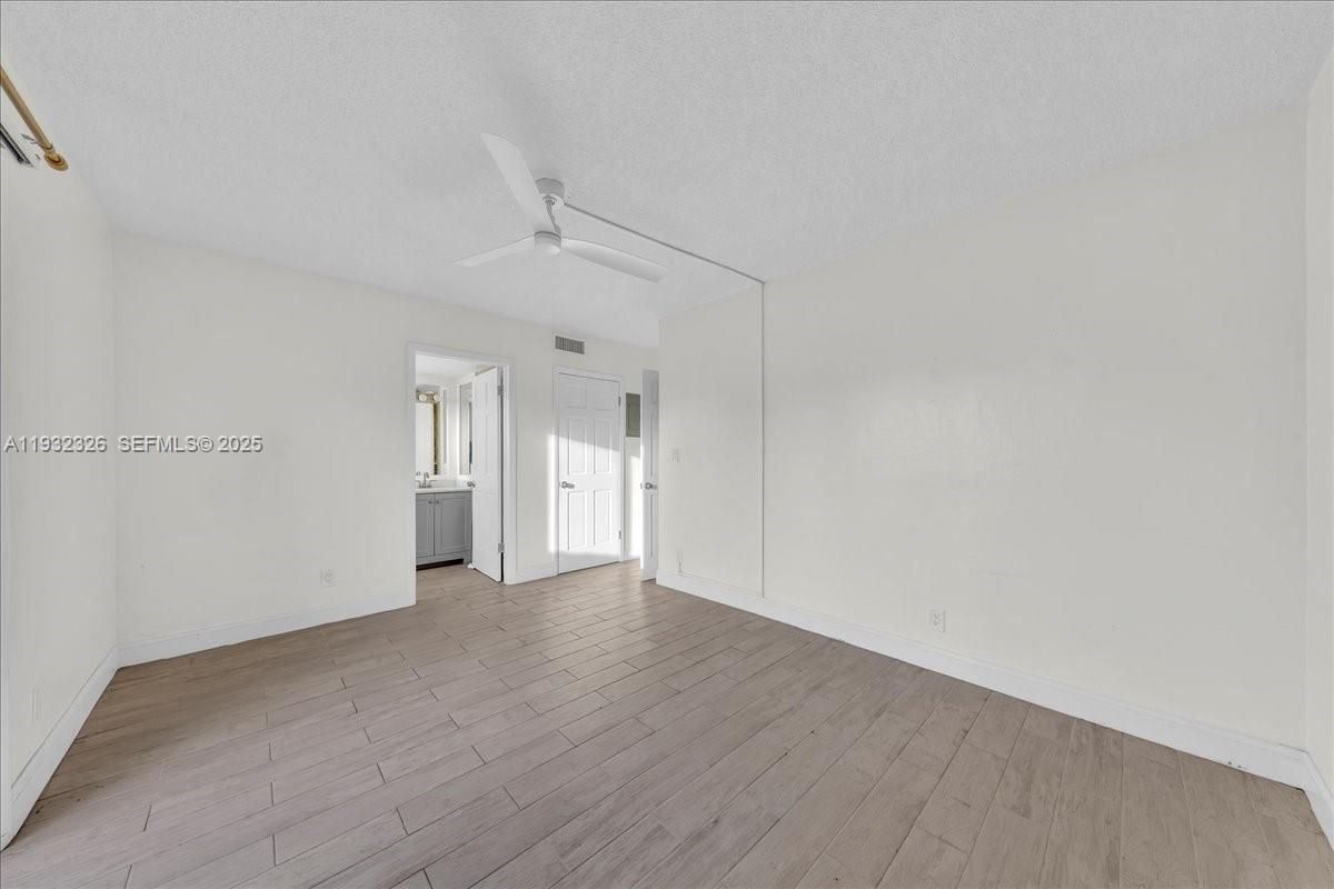 2025 Miami Road, Unit 19 Fort Lauderdale, FL 33316 - Photo 22 of 30 a view of an empty room with wooden floor