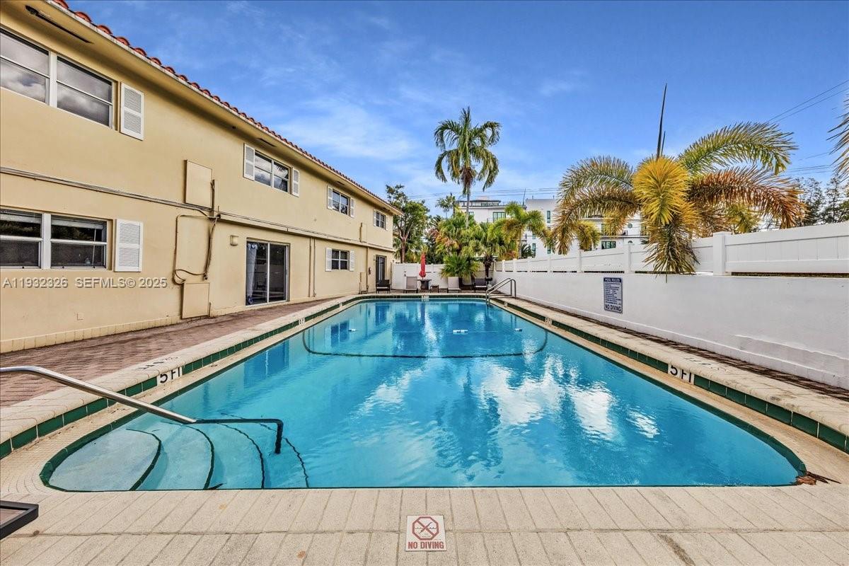 2025 Miami Road, Unit 19 Fort Lauderdale, FL 33316 - Photo 29 of 30 a view of swimming pool with outdoor seating and plants
