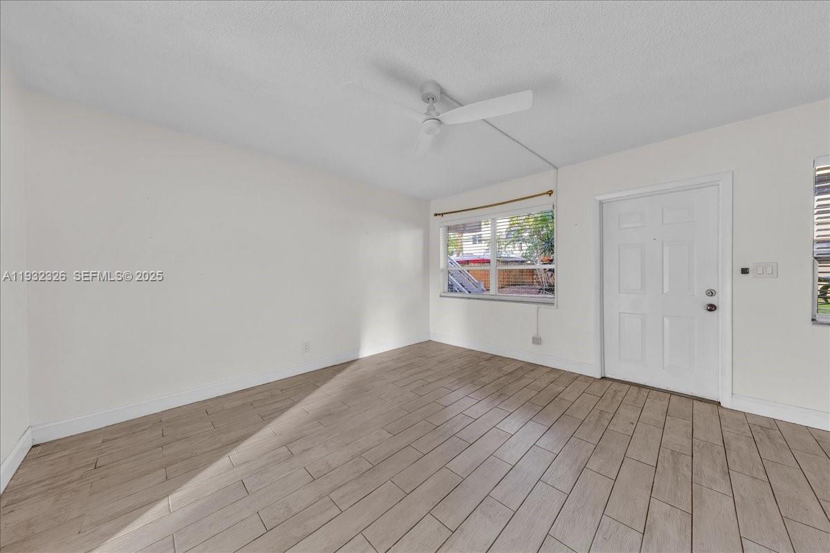 2025 Miami Road, Unit 19 Fort Lauderdale, FL 33316 - Photo 8 of 30 wooden floor in an empty room with a window